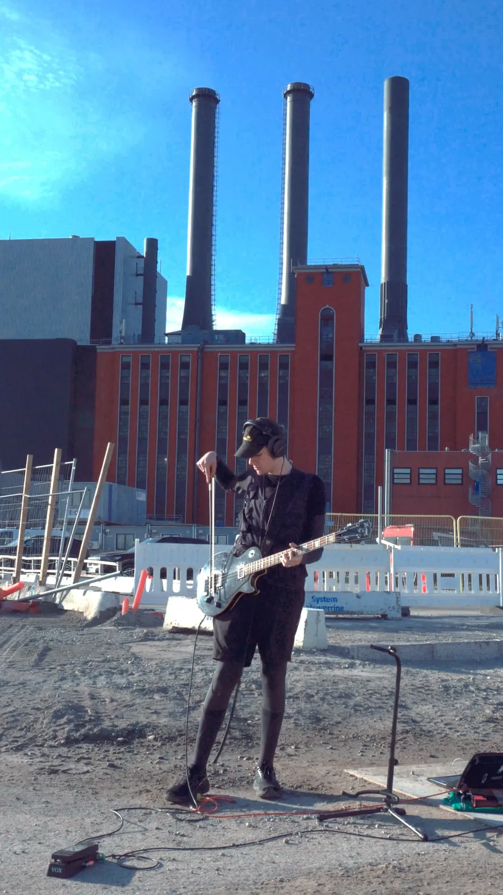 Playing bass in an industrial landscape.